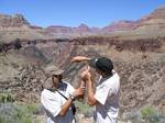 Doug removs cactus spines from Roger's hand in Grand Canyon - April, 2006